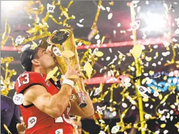  ?? Wally Skalij Los Angeles Times ?? GEORGIA QUARTERBAC­K Stetson Bennett, a former walk-on, celebrates with the national title trophy.