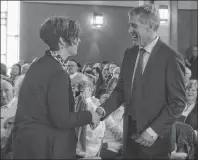  ?? DAVID JALA/CAPE BRETON POST ?? Dr. Allan Rosenfeld, right, is thanked by Pam Van Dommelen following his address to a crowd of about 200 people that gathered Sunday at Sydney’s Temple Sons of Israel Synagogue for a Holocaust memorial service. Rosenfeld gave an emotional and stirring...