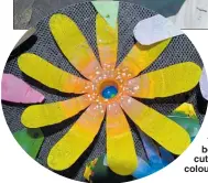  ??  ?? Madeleine Watts, 13 made the purple and yellow double flower at left. The flowers made from plastic drink bottles were carefully cut and shaped with colour painted on.