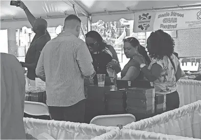  ??  ?? Taneta Hicks, Kristen Ellison and Sharon Hicks inspect cigars at the Beale St. Cigar Festival, held at Handy Park on Sept. 1. LINDA A. MOORE/THE COMMERCIAL APPEAL