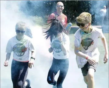  ??  ?? Julia Jakob, Ellie Mai Moran and Luke Leddu taking part in the Ardmore Rovers Colour Rush at Ballywaltr­im Park.