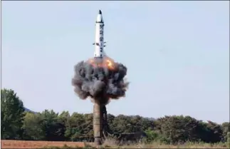  ?? KCNA VIA KNS/AFP ?? A North Korean medium-to-long-range strategic ballistic missile Pukguksong-2 being launched in a test-fire.