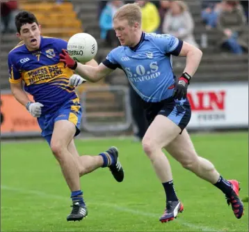  ??  ?? Sea n Gaul of St. Anne’s is tracked by Gusserane’s Jack Burford during their SFC quarter-final.
