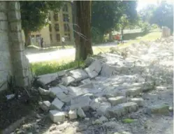  ??  ?? The students pulled down the wall fence that demarcates Evelyn hone from the National Institute for Public Administra­tion (NIPA)