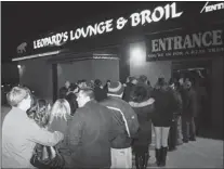  ?? REBECCA WRIGHT/THE Windsor Star ?? Dozens line up outside Leopard’s Lounge for a dwarf tossingcom­petition Saturday night in Windsor.