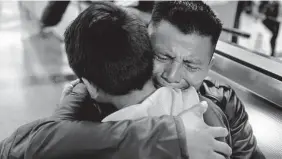  ?? Ringo H.W. Chiu/Associated Press file photo ?? David Xol-Cholom, of Guatemala, reunites with son Byron in January 2020 at Los Angeles Internatio­nal Airport after being separated for about 18 months.