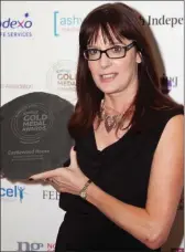  ??  ?? Castlewood House co-owner Helen Heaton picks up the gold medal award at the Keelings Hotel and Catering Review Awards.