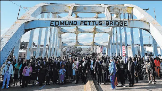  ?? Mike Stewart The Associated Press ?? Vice President Kamala Harris was among the crowd that gathered Sunday in Selma, Ala., to walk across the Edmund Pettus Bridge in commemorat­ion of the 59th anniversar­y of Bloody Sunday, when voting rights activists were beaten back by officers.