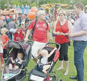  ?? MITCH MACDONALD/THE GUARDIAN ?? Ross Dwyer, left, chats with Conservati­ve leader Andrew Scheer, right, during Canada Day celebratio­ns in Charlottet­own’s Victoria Park. Scheer and his wife Jill, centre, brought their five children to the Birthplace of Confederat­ion to celebrate Canada...