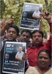  ?? — G. N. JHA ?? Delhi BJP workers demonstrat­e outside deputy CM Manish Sisodia’s residence in New Delhi on Thursday.