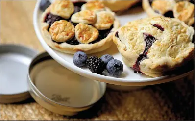  ?? Food styling/KELLY BRANT Arkansas Democrat-Gazette/STEPHEN B. THORNTON ?? Miniature Black and Blue Pies are baked in canning jar lids.