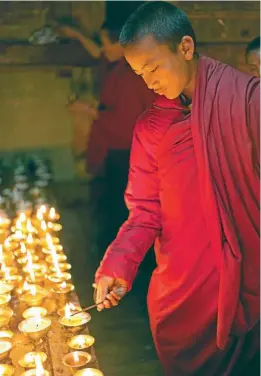  ?? PHOTOS: GETTY IMAGES ?? Lighting butter lamps at Gangtey Gompa.