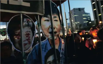  ?? PICTURE: AP ?? South Korean protesters with portraits of impeached President Park Geun-hye march toward the BlueHouse during a candle light vigil calling for her arrest in Seoul on Saturday.