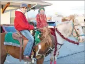  ?? TIMES photograph­s by Annette Beard ?? Horses and their riders are a standard part of the annual Pea Ridge Christmas parade. Brandy’s Boutique won Best Equestrian entry this year.