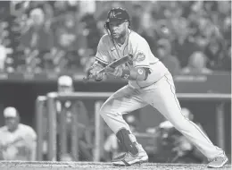  ?? ALEX BRANDON/AP ?? Mets second baseman Robinson Cano drops a bunt single against the Nationals during the fifth inning April 7 in Washington.