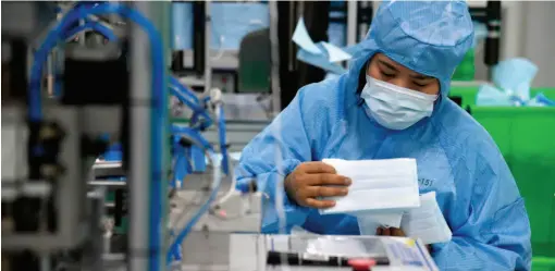  ??  ?? January 28, 2020: Workers produce medical masks under sterile conditions in the workshop of Qingdao Hainuo Bioenginee­ring Co., Ltd. Medical protective equipment manufactur­ers in the city of Qingdao have made an emergency cancellati­on of the Spring Festival holiday and endeavored to produce protective gears such as medical masks. by Li Ziheng/xinhua