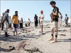  ?? SALEH AL-OBEIDI ?? Yemenis gather near Al-Sawlaban base in Aden’s Al-Arish district yesterday after a bomber targeted a crowd of soldiers.