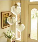  ?? ?? Add a statement look to a high ceiling with cascading glass pendant that draws the eye up Laura Ashley Whitham 3 light cluster
pendant in Antique Brass and glass, £160, där lighting