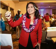  ?? — AP ?? Rising star: Gabbard greeting supporters in Honolulu in this file picture. She is the first Hindu member of Congress and its first Samoan American.