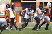  ?? AP Photo/Eric Gay ?? ■ TCU quarterbac­k Max Duggan (15) runs against Texas during the first half of an NCAA college football game Saturday in Austin.