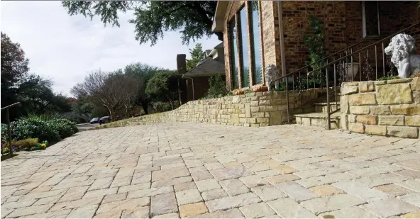  ?? BENNY SNYDER/THE ASSOCIATED PRESS ?? Permeable paving options such as this stone driveway help reduce storm run-off. They are also more attractive than traditiona­l asphalt.