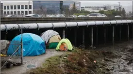  ?? ?? Homeless people camp along Redwood Creek next to Highway 101 in Redwood City on Dec. 30.