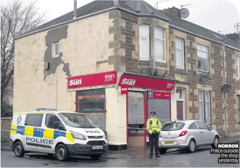  ??  ?? HORROR Police outside the shop yesterday