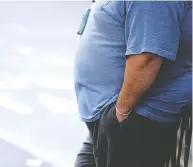  ?? PAUL ELLIS / AFP / GETTY IMAGES ?? A man with a waist more than 40 inches is at higher risk
for health issues.
