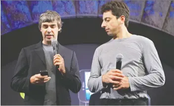  ?? REUTERS/FILE ?? Larry Page and Sergey Brin, who founded Google in 1998 in a garage, are seen in 2008 with a G1 phone running Google’s Android software. They have both stepped back from daily operations of the company.