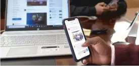  ?? TONY KARUMBA/AFP VIA GETTY IMAGES ?? In this file photo, taken April 2020, a man browses through his social media.