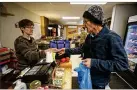  ?? GENE J. PUSKAR/AP ?? Dianne Shenk (left), owner of Dylamatos Market in Pittsburgh, lauds SNAP choices.