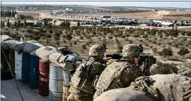  ??  ?? HIGH ALERT: US special forces scan the area around the city of Manbij