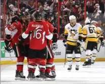  ?? JANA CHYTILOVA, GETTY IMAGES ?? Mike Hoffman (68) of the Sens celebrates with teammates after scoring a goal against Pittsburgh in the third period in Ottawa on Tuesday night.