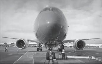  ?? LONDON
-REUTERS ?? An employee carries out checks on a Boeing Co. 787 Dreamliner passenger aircraft operated by Norwegian Air Shuttle AS, at Gatwick Airport outside London.