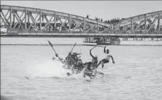  ?? AFP ?? A team of pirogue racers fall off their boat during victory celebratio­ns in Saint-Louis on Saturday.