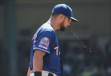  ?? LOUIS DELUCA — THE ASSOCIATED PRESS ?? Rangers third baseman Isiah Kiner-Falefa spits during a 2019game against the Red Sox in Arlington, Texas.