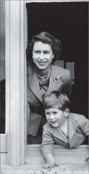  ?? PICTURE: PA WIRE ?? HAPPY PRINCE: Charles on his fourth birthday, leaning out of a window with his mother, the Queen – one of the images released to celebrate his 70th birthday.