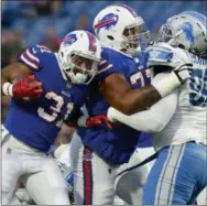  ?? ADRIAN KRAUS — THE ASSOCIATED PRESS FILE ?? In this file photo, Buffalo Bills running back Jonathan Williams (31) follows the block of tackle Cordy Glenn (77) against Detroit Lions defensive tackle Khyri Thornton (99) during the first half of a preseason NFL football game in Orchard Park, N.Y. A...