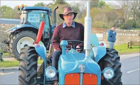  ??  ?? Donald Murchie shows his support for the NHS at the tractor parade.