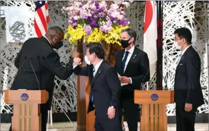  ?? XINHUA ?? US Defense Secretary Lloyd Austin (left) greets Japanese Foreign Minister Toshimitsu Motegi in Tokyo on March 16 after talks with US Secretary of State Antony Blinken and Japanese Defense Minister Nobuo Kishi.