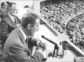  ?? IN THE BROADCAST Associated Press ?? booth in the 1960s: Scully and his announcing teammate Jerry Doggett.
