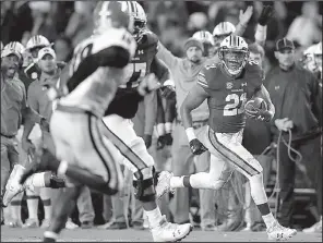  ?? AP/Atlanta Journal-Constituti­on/CURTIS COMPTON ?? Auburn running back Kerryon Johnson (right) ran for 167 yards Saturday and caught a 55-yard touchdown pass to lead the No. 10 Tigers to a 40-17 victory over the top-ranked Georgia Bulldogs in Auburn, Ala.