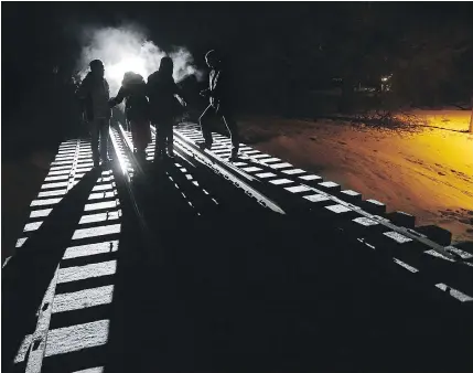  ?? — THE CANADIAN PRESS FILES ?? On February 26, eight migrants from Somalia crossed into Canada illegally from the United States by walking down this train track into Emerson, Man.