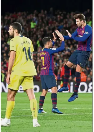  ??  ?? Perfectly timed: Barcelona’s Gerard Pique (right) celebratin­g with teammate Philippe Coutinho after scoring against Villarreal during their La Liga match on Sunday. — Reuters