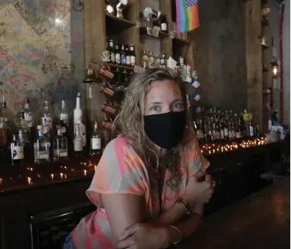  ?? AP ?? SEEING BOTH SIDES: Danielle Savin is seen at her Miami Beach bar, Bob’s Your Uncle. Savin owns two bars that were forced to shut down for months in both New York and Miami.