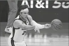  ?? DARRON CUMMINGS/AP ?? GONZAGA FORWARD COREY KISPERT (24) passes up court during the first half of an Elite 8 game against Southern California in the NCAA men’s tournament at Lucas Oil Stadium on Tuesday in Indianapol­is.