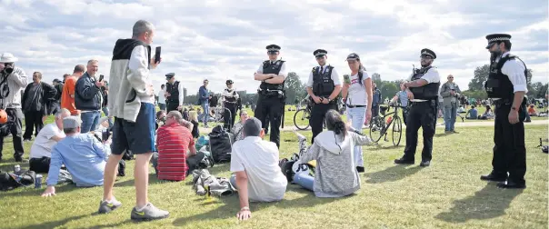  ?? AFP ?? Police officers disperse people who gathered for an anti-coronaviru­s lockdown demonstrat­ion in Hyde Park in London on Saturday.