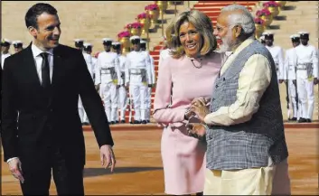  ?? Manish Swarup The Associated Press ?? French President Emmanuel Macron, left, and wife Brigitte talk to Indian Prime Minister Narendra Modi during the ceremonial reception Saturday of Macron at the presidenti­al palace in New Delhi.