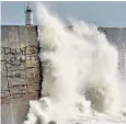  ??  ?? Storm Bronagh brought waves crashing over the harbour wall at Newhaven