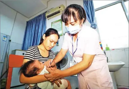  ?? AFP ?? A child receives a vaccinatio­n shot at a hospital in Rongan in China’s southern Guangxi region on Monday. Chinese Premier Li Keqiang has vowed stern action over the latest safety scare to hit the country’s pharmaceut­ical industry, as a mounting scandal over a rabies vaccine sent drug stocks tumbling.